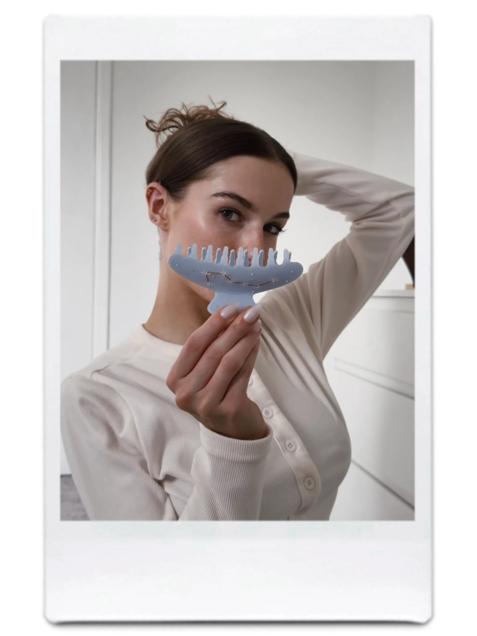 Model holding Big Dipper Hair Claw in blue – stylish close-up of elegant hair accessory.