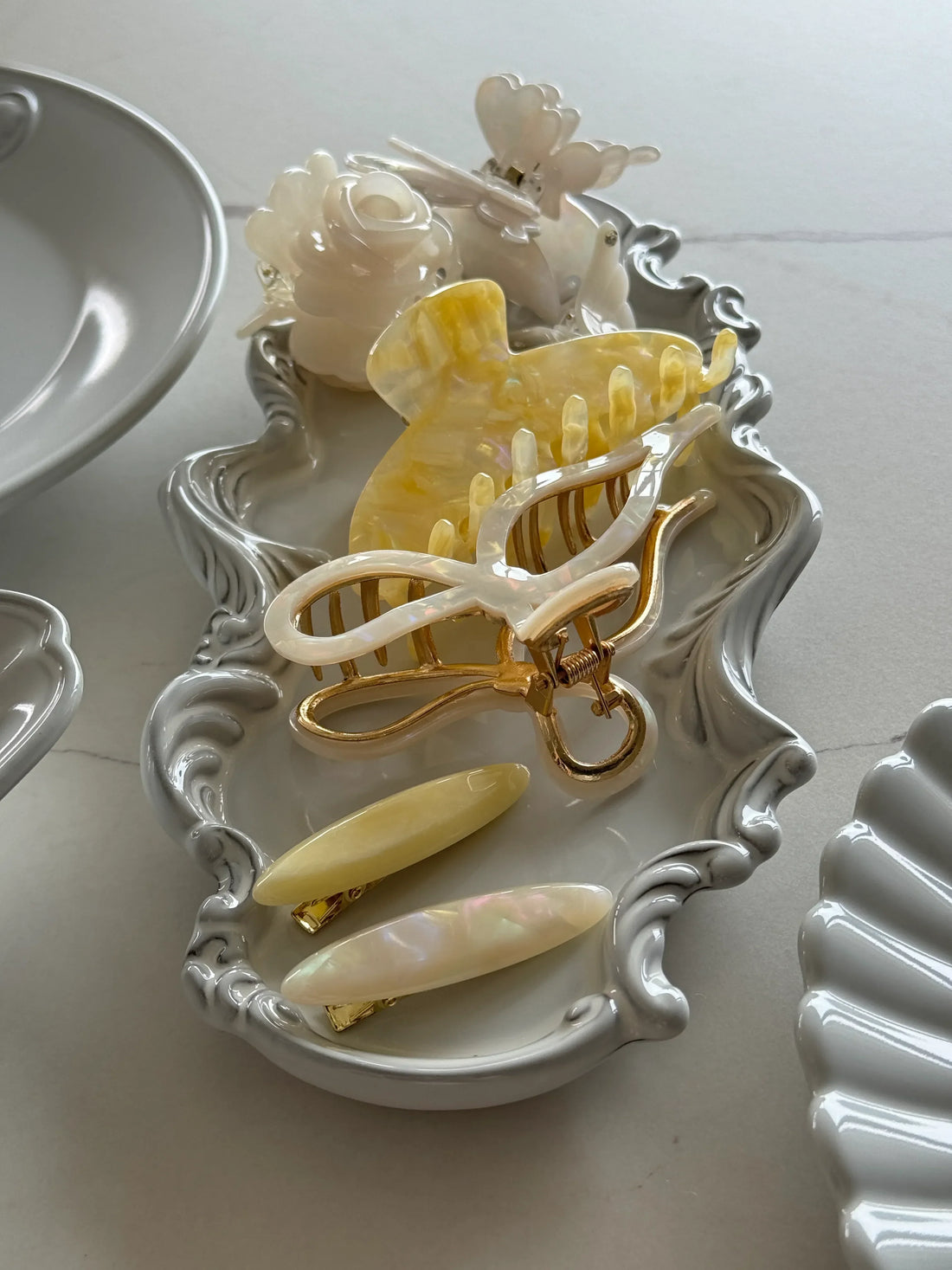 Elegant wedding hair accessories including tiaras, pearl pins, and floral clips from Irisa Rosa.
