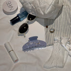 Lifestyle flatlay – Blue Big Dipper Hair Claw styled with chic accessories