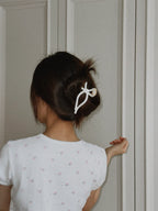 Model wearing bow claw clip – chic hairstyle with hair accessory