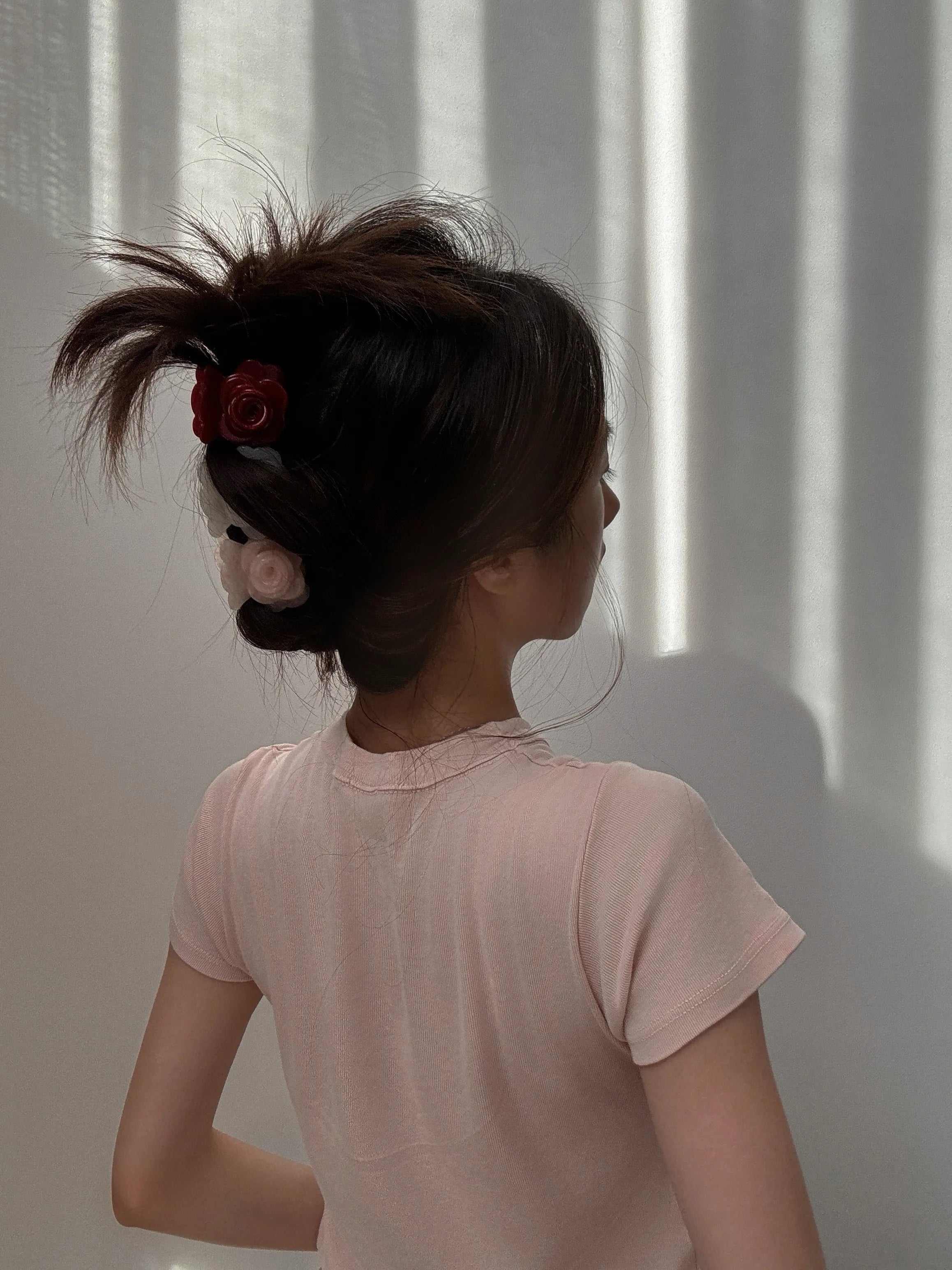 Model wearing Petit Rose Hair Claw in Pink – elegant floral claw clip