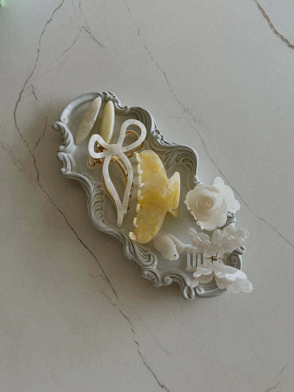 Irisa Rosa yellow hair claw clip lifestyle photo on tray with accessories