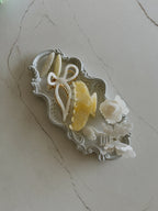 Irisa Rosa yellow hair claw clip lifestyle photo on tray with accessories