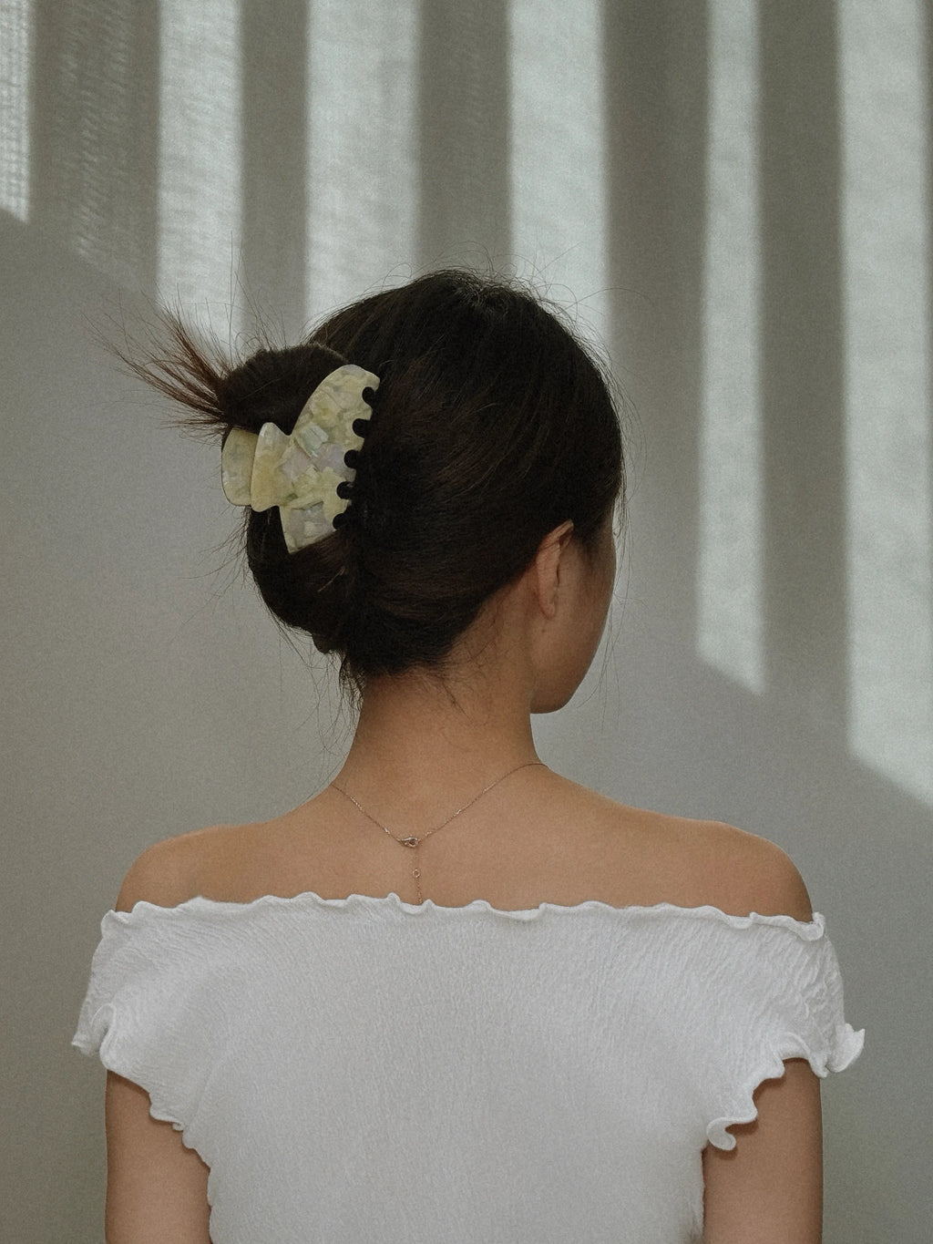 Model wearing Irisa Rosa yellow hair claw clip – back view styling