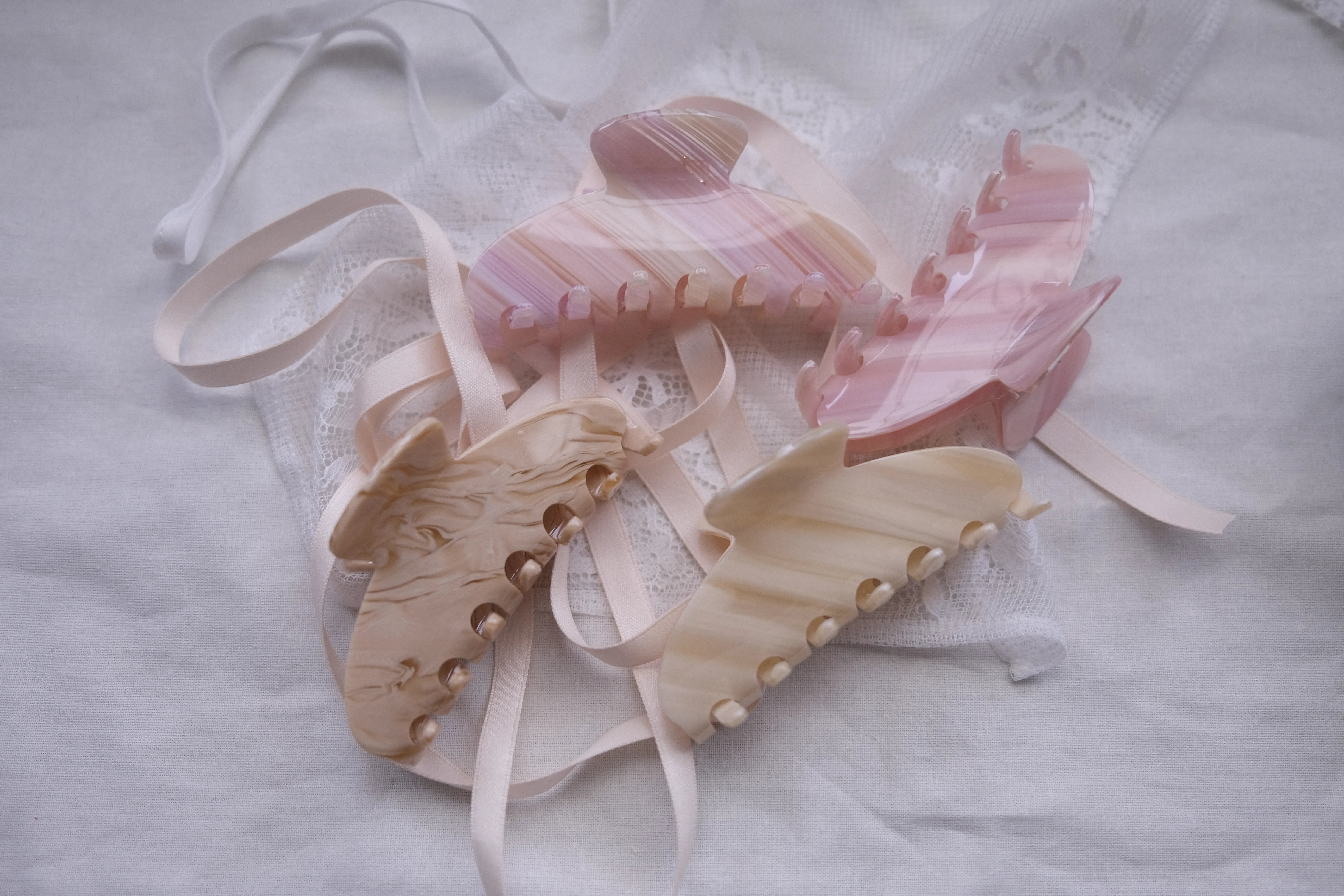 Irisa Rosa pastel pink and beige hair claw clips displayed beside newsletter subscription section