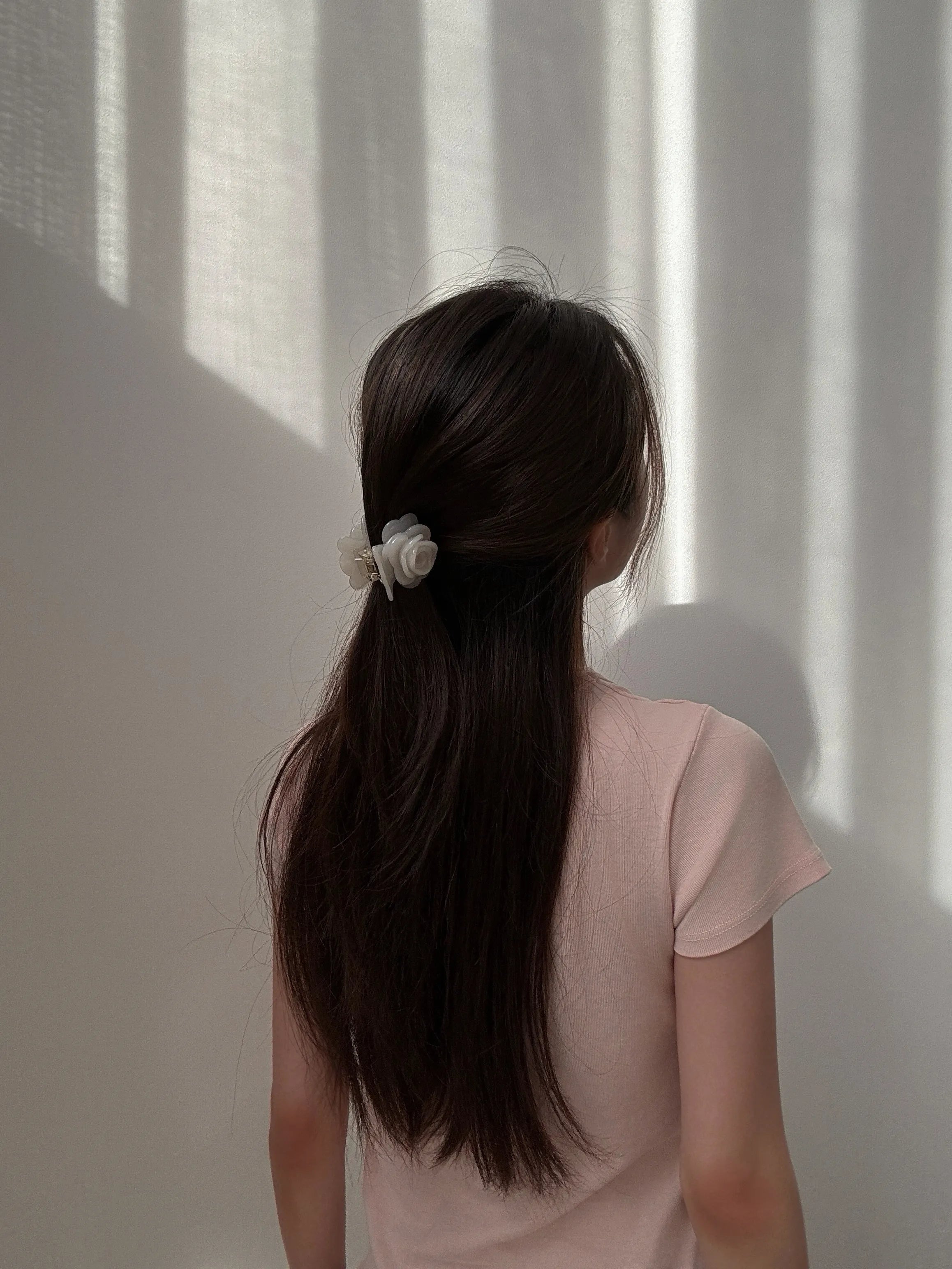 Model wearing Petit Rose Hair Claw in White – elegant floral hair clip