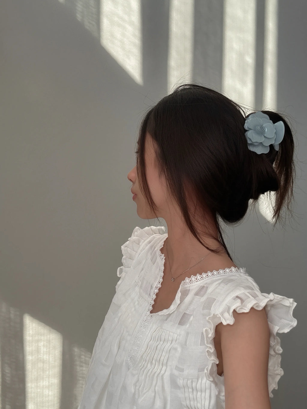 Model styling with Grande Rose Claw in Blue – chic and secure hair claw clip