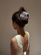 Model styling with grey Camellia Hair Claw – chic floral hair accessory for daily and wedding looks