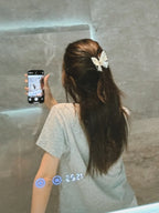 Model wearing Sparkle Flutter White Butterfly Hair Claw – trendy hair accessory for women